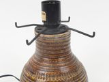 an image of a brown vase with a black top on a white background