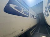 two semi trucks parked side by side in a parking lot