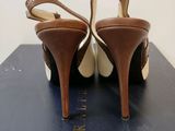 the heel of a pair of brown high heeled shoes sitting on top of a blue box