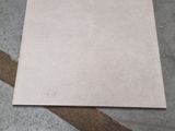 a piece of paper on the floor next to a piece of tape
