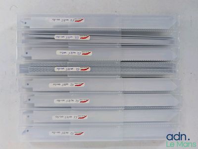six clear plastic dividers with red and white labels on them