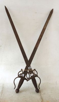 a pair of scissors on a stand on the floor