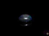 an image of a black oplite ball in the dark