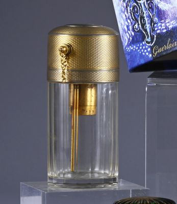 a bottle of perfume next to a box of perfume on a table
