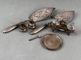 a small silver object with a coin next to it