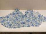 two pieces of blue and white floral fabric on a white table