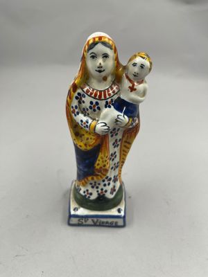 une figurine représentant une femme tenant un bébé dans ses bras