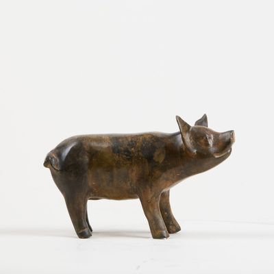 bronze figurine of a pig on a white background