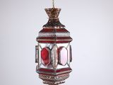 a close up of a red and gold lantern hanging from a ceiling