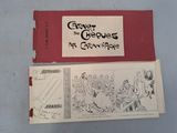 two pages of comics on a table with a red cover