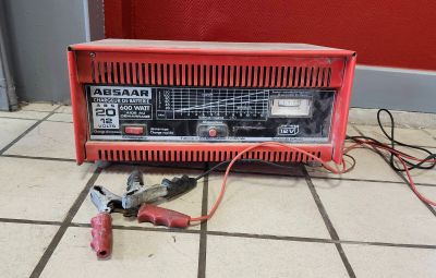 a red machine that is sitting on a tile floor