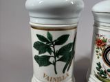two salt and pepper shakers sitting on a table