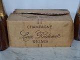 three bottles of champagne sitting next to each other on a table