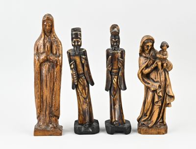 three wooden figurines of people standing next to each other