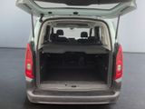the back end of a silver van with its trunk open