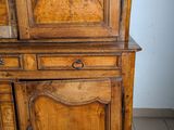 a wooden cabinet with a door on top of it