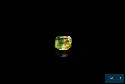 a green and yellow diamond on a black background