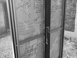 black and white photograph of a sign with writing on it