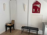 an image of a living room with white walls and wood flooring