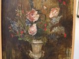 a painting of flowers in a vase on a easel