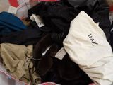 a bag full of clothes that is sitting on the floor