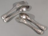 quatre cuillères en argent et deux fourchettes en argent sur une table