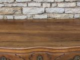 a small chest of drawers with carvings on the front