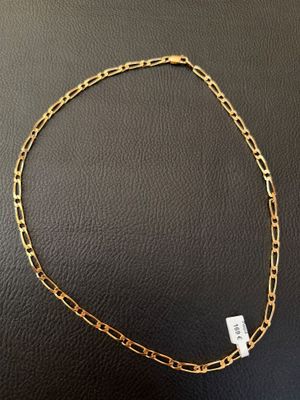 a gold chain necklace with a small white diamond on it