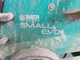 a close up of a small engine on a green vehicle