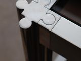 a piece of a puzzle sitting on top of a wooden table