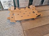 une boîte en carton posée par terre, percée de trous