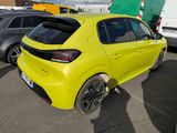 a yellow car parked in a parking lot with other cars