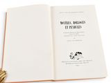 an open book with a tassel on top of it on a white surface