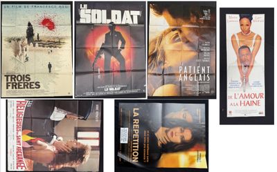 many movie posters on the wall of a room