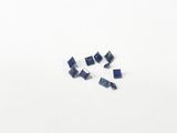 a group of blue sapphires sitting on top of a white surface