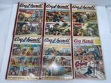 several comics are on display on a table in front of a white background