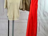 two dresses hanging on a clothes rack in a room