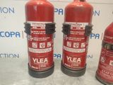 three fire extinguisors that are sitting on a table