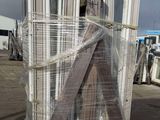 a large pile of metal tubes wrapped in plastic