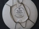 a white plate with a metal holder on top of it