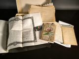 a open book sitting on a table next to a pile of papers