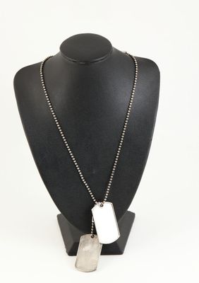 Collier avec plaque d'identité en argent sur un mannequin noir muni d'une chaîne