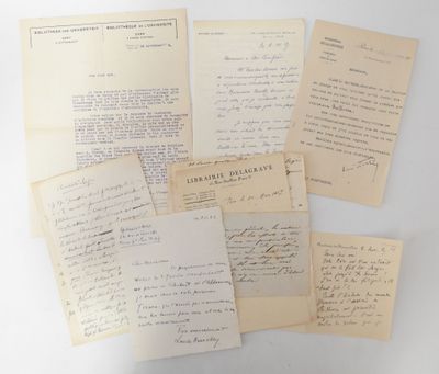 several old papers are stacked on top of each other on a table