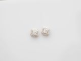 a pair of diamond earrings on a white surface