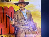 a poster of a man holding a gun on a wall