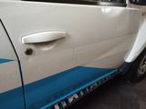 a white car with a blue stripe on the side of it
