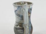 a blue and white vase sitting on a white surface