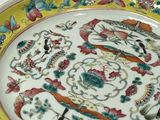 a colorful plate with birds and flowers on it