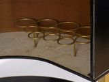 a black and gold cabinet with gold rings on it