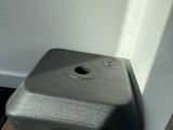 a black piece of luggage sitting on the floor next to a door